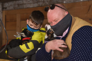 photo of holdng newborn goats