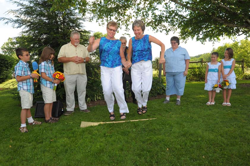 same sex brides jumping the broom at the old tater barn schoharie ny